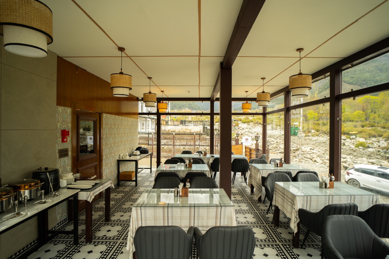 Scenic outdoor terrace views overlooking mountains and stream from Brookside Cafe, Pahalgam