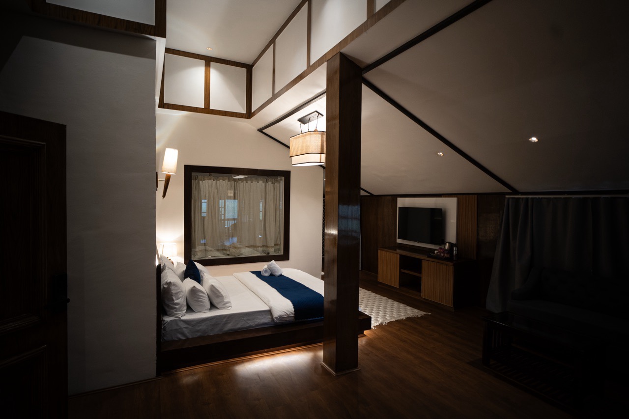 Generous studio layout living area featuring plush seating and mountain-facing glass doors at Walnut Village Resort