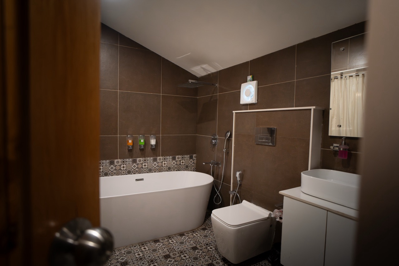 Luxury soaking bathtub positioned next to a large window with scenic mountain views in the Premium Studio